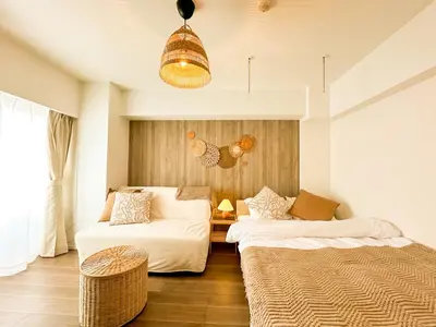 a room with two beds and a table at Syforme Keikyu-Kamata Residence in Tokyo