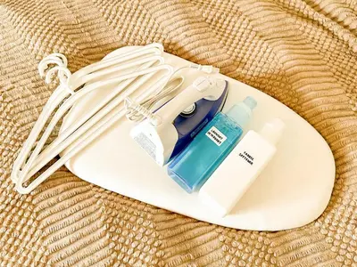 a white surfboard with a bottle on it at Syforme Keikyu-Kamata Residence in Tokyo