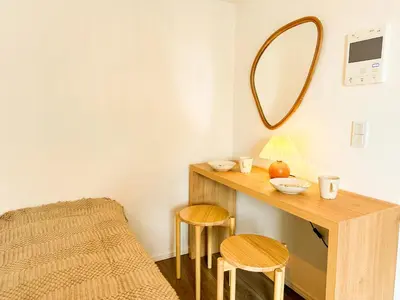 a dressing table with two stools and a mirror at Syforme Keikyu-Kamata Residence in Tokyo