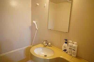 a bathroom with a sink and a mirror at 406Room,With elevator, 700m 4 min walk from Nishi-Shinjuku 5-chome, direct access to Shinjuku, 28 sqm in Tokyo