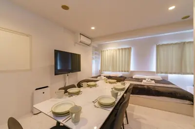 a room with a dining table and a bed at feel Akihabara STAY in Tokyo