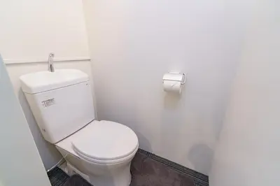 a bathroom with a toilet and a roll of toilet paper at feel Akihabara STAY in Tokyo