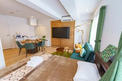 a living room with a bed and a dining room at feel Akihabara STAY in Tokyo