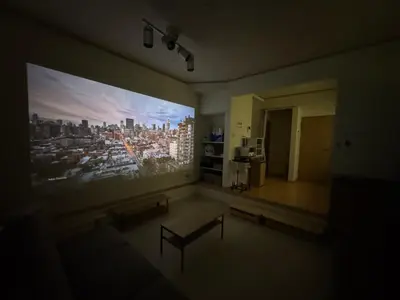 a room with a large painting of a city on the wall at HOTEL Japonica ANX in Tokyo