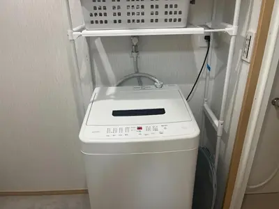 a white washer and dryer in a small room at HOTEL Japonica ANX in Tokyo