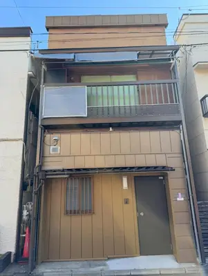 an external view of a building with a door and a balcony at HOTEL Japonica ANX in Tokyo
