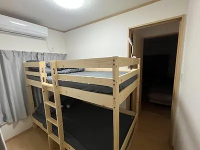 a bunk bed in a room next to a door at HOTEL Japonica ANX in Tokyo
