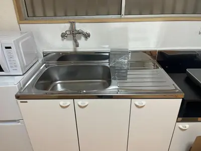 a kitchen with a sink and a microwave at HOTEL Japonica ANX in Tokyo