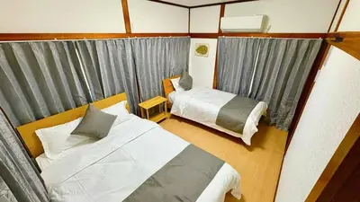 a small room with two beds and a window at \u5d50-\u6c60\u888b4\u5206\u65b0\u5bbf15\u5206 in Tokyo
