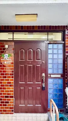 a red door of a brick building with at \u5d50-\u6c60\u888b4\u5206\u65b0\u5bbf15\u5206 in Tokyo