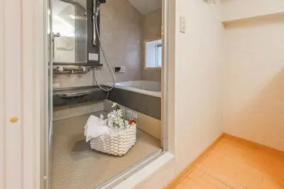 a small kitchen with a sink and a basket of flowers at Shinjuku 2 stops 3 bedrooms best groups or family in Tokyo