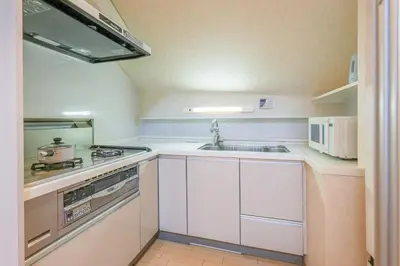 a small kitchen with a sink and a stove at Shinjuku 2 stops 3 bedrooms best groups or family in Tokyo