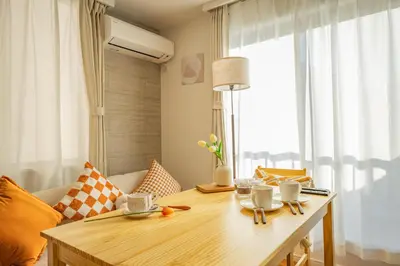 a living room with a wooden table and a window at ikebukuro three storey villa,three bedrooms,9-10 people in Tokyo