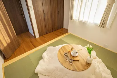 a wooden table in the middle of a room at ikebukuro three storey villa,three bedrooms,9-10 people in Tokyo