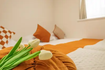 a bouquet of tulips on a bed with a bed at ikebukuro three storey villa,three bedrooms,9-10 people in Tokyo