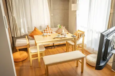 a small living room with a table and chairs at ikebukuro three storey villa,three bedrooms,9-10 people in Tokyo