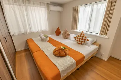 a bedroom with a bed with a pumpkin on it at ikebukuro three storey villa,three bedrooms,9-10 people in Tokyo