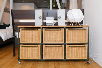 a desk with three baskets and a computer on it at Keiko House in Tokyo