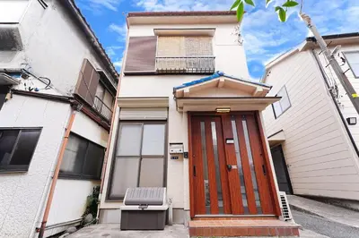 a house with a wooden door in front of it at Industrial room in Tokyo