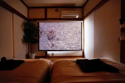 a room with two beds and a large window at Industrial room in Tokyo