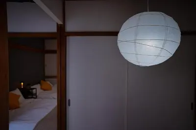 a room with a bed and a white lamp at Industrial room in Tokyo