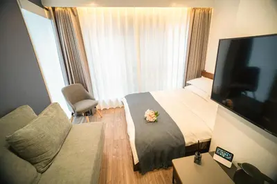 a hotel room with a bed with a flower on it at \u30dc\u30eb\u30bf\u30e9\u6e0b\u8c37 in Tokyo