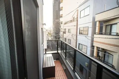 a balcony of a building with a bench on it at \u30dc\u30eb\u30bf\u30e9\u6e0b\u8c37 in Tokyo
