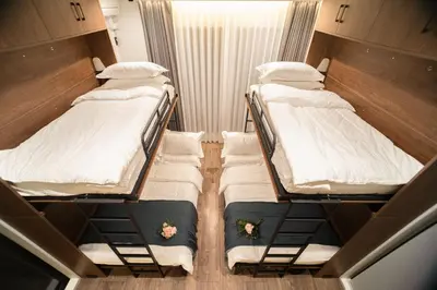 two bunk beds in a small room with flowers on them at \u30dc\u30eb\u30bf\u30e9\u6e0b\u8c37 in Tokyo