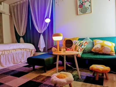 a living room with a couch and a table with a mirror at Ciel de Kagurazaka Familial iidabashi \u65b0\u5bbf\u795e\u697d\u5742\u98ef\u7530\u6a4b ## Shuttle, Ticket, Restaurant reservation service ## in Tokyo
