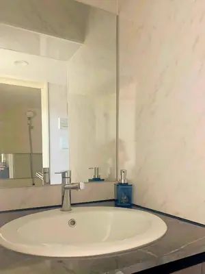 a white sink in a bathroom with a mirror at Ciel de Kagurazaka Familial iidabashi \u65b0\u5bbf\u795e\u697d\u5742\u98ef\u7530\u6a4b ## Shuttle, Ticket, Restaurant reservation service ## in Tokyo