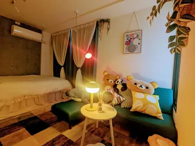 two teddy bears sitting on a couch in a bedroom at Ciel de Kagurazaka Familial iidabashi \u65b0\u5bbf\u795e\u697d\u5742\u98ef\u7530\u6a4b ## Shuttle, Ticket, Restaurant reservation service ## in Tokyo