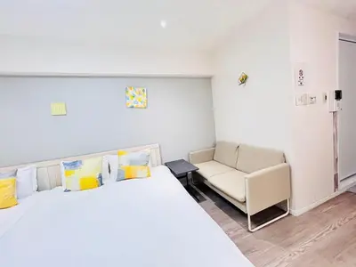 a bedroom with a bed and a couch and a chair at ying-Shinjuku hostel-SJ0055 in Tokyo