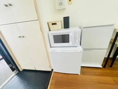a microwave sitting on top of a refrigerator at ying-Shinjuku hostel-SJ0055 in Tokyo