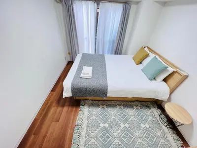 a bedroom with a bed with a rug and a window at ying-Shinjuku hostel-SJ0055 in Tokyo