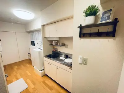 a small kitchen with a refrigerator and a sink at ying-Shinjuku hostel-SJ0055 in Tokyo