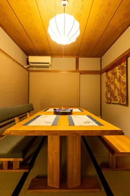a dining room with a wooden table and chairs at The Guest House Sakura in Tokyo