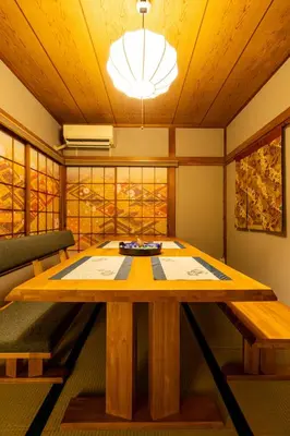 a dining room with a table and a couch at The Guest House Sakura in Tokyo