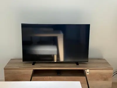 a flat screen tv sitting on top of a wooden stand at Luce Stay&Resort Evoluto101 in Urayasu