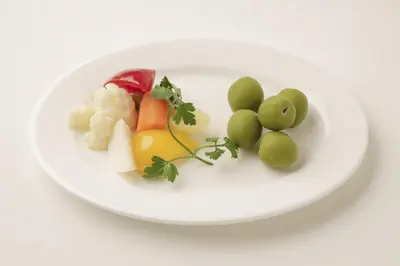 a plate of vegetables and grapes on a white plate at Luce Stay&Resort Evoluto101 in Urayasu