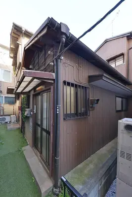 a house with a street light on the side of it at Joyfull House in Tokyo