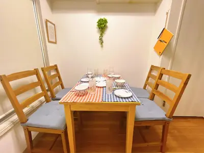 a wooden table with plates and glasses on it at April House Ikebukuro in Tokyo