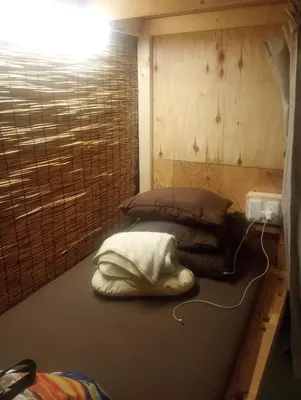 a room with two beds in a room with a wall at Edo Tokyo Sharehouse Long Stay Only, One month plus in Tokyo