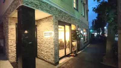 a brick building with illuminated windows on a street at \u30dc\u30f3\u30a2\u30fc\u30c8\u702c\u7530 in Tokyo