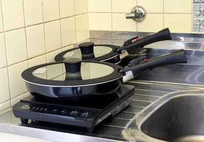 a pot sitting on top of a stove next to a sink at Shinjuku Vintage Rooftop Terrace Stay in Tokyo