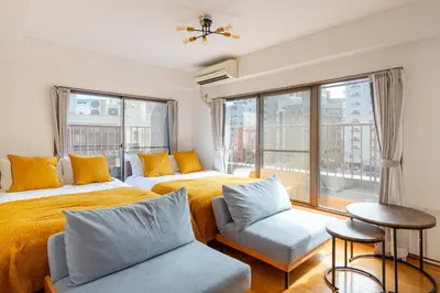 a bedroom with two beds and a window at Shinjuku Vintage Rooftop Terrace Stay in Tokyo