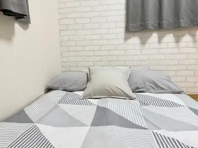 a bed with two pillows on it in a bedroom at Shinjuku Cloudlive AH in Tokyo