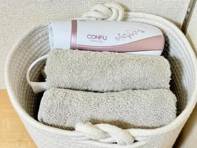 a basket filled with towels and a detergent at Shinjuku Cloudlive AH in Tokyo