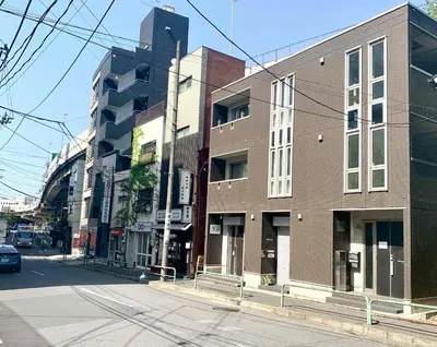 a brick building on a city street with a car at Monzennakacho Royal Residence in Tokyo