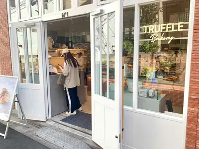 a woman standing in the doorway of a coffee shop at Monzennakacho Royal Residence in Tokyo