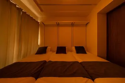 a bedroom with a large bed with two pillows at Terrace Tokyo Otsuka South in Tokyo